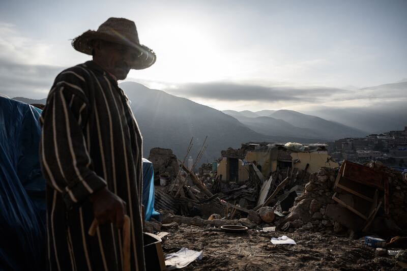 An earthquake survivor stands in front of a makeshift tent in the village of Moulay Brahim in the Atlas Mountains, in the central province of Al-Haouz. Photograph: Philippe Lopez/AFP via Getty Images