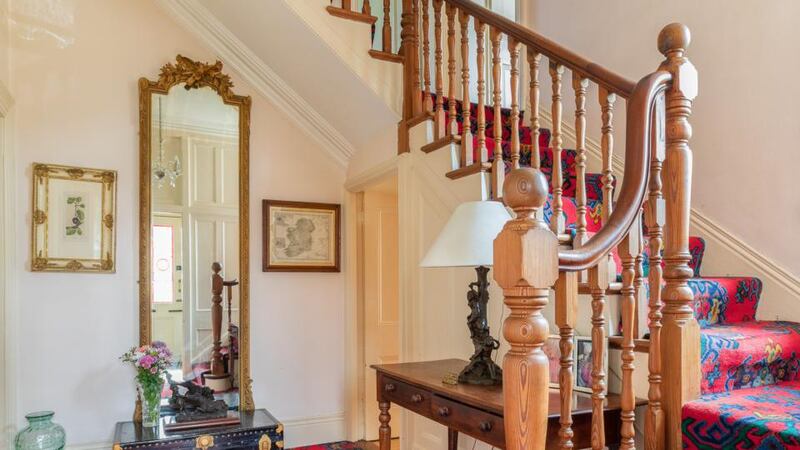 A carved timber staircase  rises up three storeys to the top of the house.