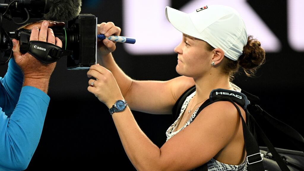 Australia’s Ash Barty signs an autograph on the TV camera after winning her quarter-final match against Jessica Pegula of the USA at the Australian Open in Melbourne. Photograph: Dave Hunt/EPA