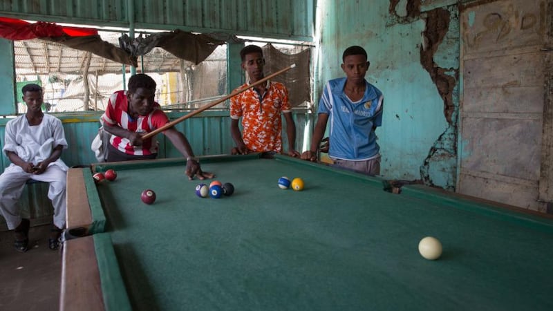 Eritrean refugees play pool in Shagarab camp, eastern Sudan. Photograph: Sally Hayden