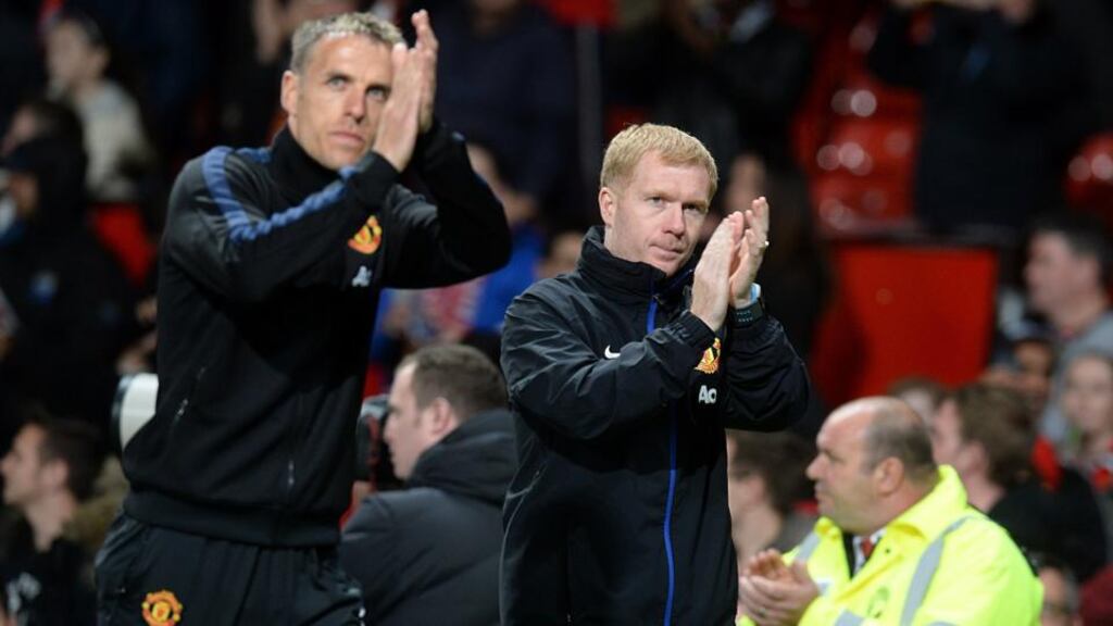 Manchester United’s Paul Scholes and Phil Neville (left) applaud the fans at Old Trafford, a venue at which United have lost nine times this season. Photograph: Martin Rickett/PA Wire.