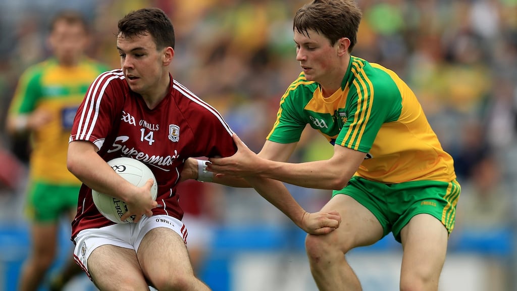 Galway’s Desmond Conneely tries to break clear of Donegal’s Mark Curran during the All-Ireland MFC semi-final at Croke Park. Photograph: Donall Farmer/Inpho