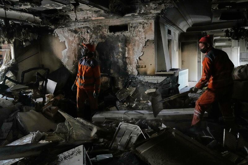 Workers clear rubble of a damaged building in Tehran. Photograph: Vahid Salemi/AP