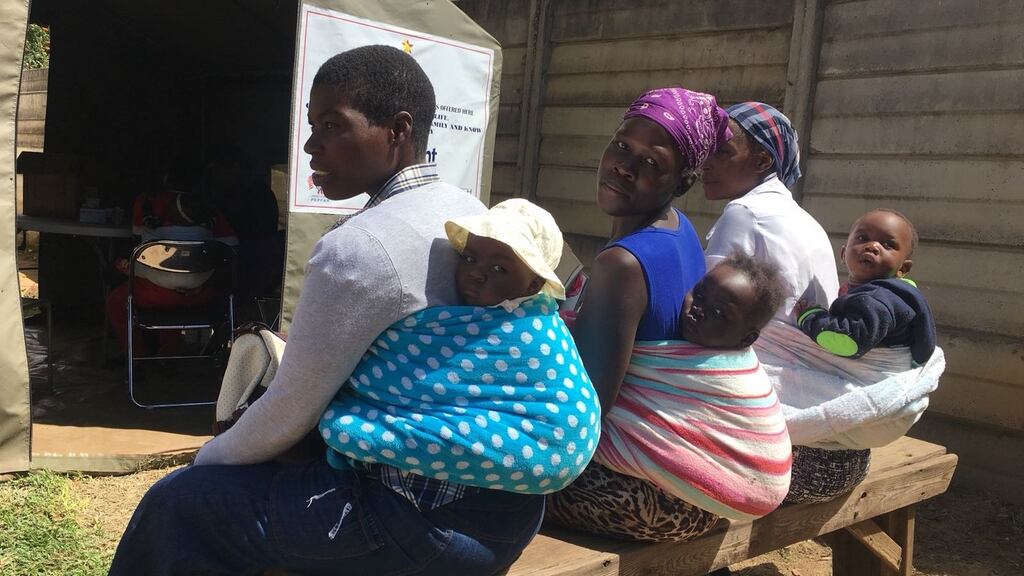 Women wait to have their babies vaccinated at a Harare hospital. Photograph: Harry McGee