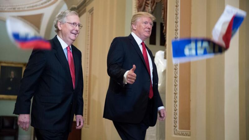 Lunch date: President Trump on his way to meet Republican senators with majority leader Mitch McConnell; a protester threw Russian flags with “Trump” printed on them. Photograph: Shawn Thew/EPA