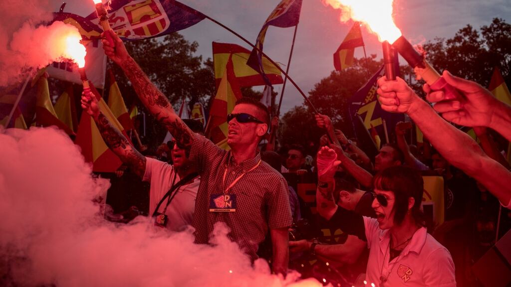 Demonstrators from far-right Spanish  groups light flares and chant slogans after marching from Plaza Espanya square  in Barcelona in mid-October. The group marched on Spain’s National Day chanting anti-separatist slogans to protest Catalonia’s push for independence. File photograph: Chris McGrath/Getty Images