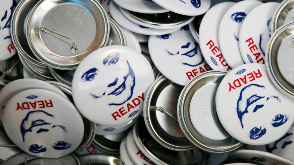 2016 campaign badges at the Buttons at the Ready for Hillary office in Alexandria, Virginia. “She is supposed to be resting and off making $200,000 speeches, but instead she’s around every political corner.” Photograph: Drew Angerer/The New York Times