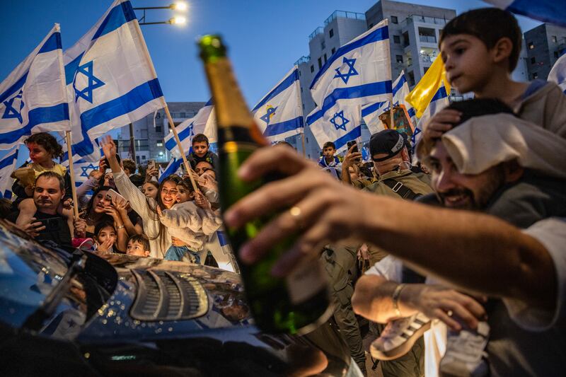 A crowd surrounding a vehicle carrying former Israeli hostage Elkana Bohbot as he arrived at his family home in Mevaseret Zion, Israel, last week. Photograph: David Guttenfelder/The New York Times