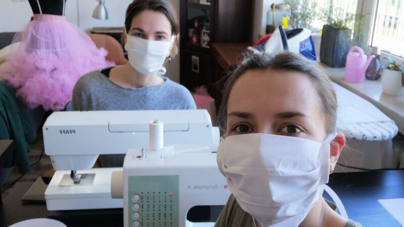 Eleonor Fischer and Wofia Winniger of the Deutsche Oper am Rhein wardrobe department, in Düsseldorf, producing protective masks.