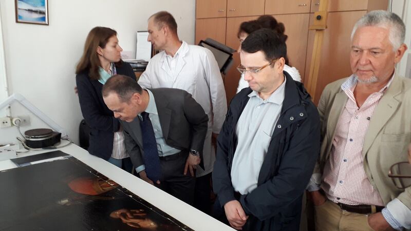 Among those viewing a depiction of The Taking of Christ in Odesa are Dr Igor Poronik (right), Director of the Odesa Museum of Western and Eastern Art; ex-ambassador of Italy to Ukraine Davide La Cecilia (leaning forward) and Papushenko Volodymyr (in white coat), of Kyiv's National Scientific-Research Restoration Centre.