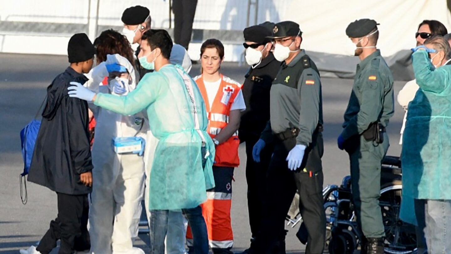 A migrant (L) disembarks from the Italian navy boat at the port of Valencia. Photograph: Jose Jordan/AFP/Getty Images