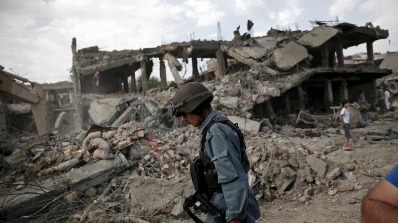 An Afghan policeman walks at the site of a truck bomb blast in Kabul on Friday. Photograph: Ahmad Masood/Reuters.