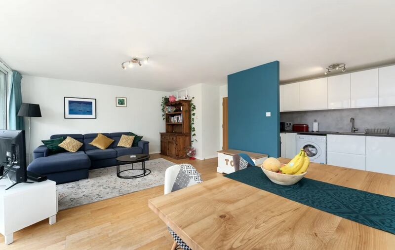 The kitchen-living-diningroom gets plenty of light as the entire rear wall is glass