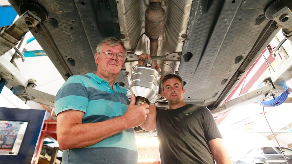 Billy Crosbie and Mark O’Donoghue of Auto Exhausts in Crumlin, Dublin 12, with a replacement catalytic converter. Photograph: Nick Bradshaw for The Irish Times