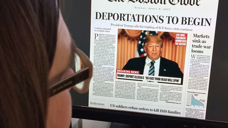 This photo taken in April 2016 shows a photo illustration taken in Washington, DC showing a woman reading The Boston Globe’s fake headline. File photograph: Karen Bleir/AFP/Getty Images