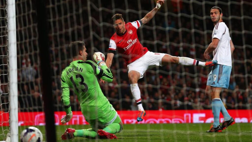 Olivier Giroud of Arsenal shoots past Adrian of West Ham United at Emirates Stadium. Photograph: Paul Gilham/Getty Images
