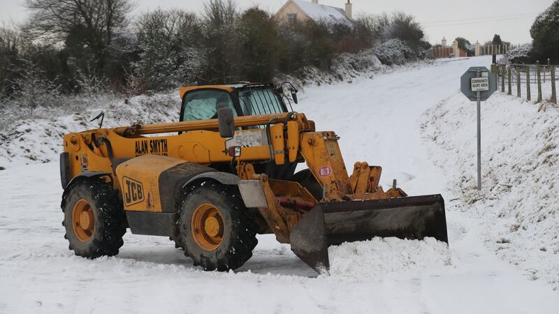 Snow is cleared from a road in Rossmore, Co Carlow. Photograph: Niall Carson/PA Wire.