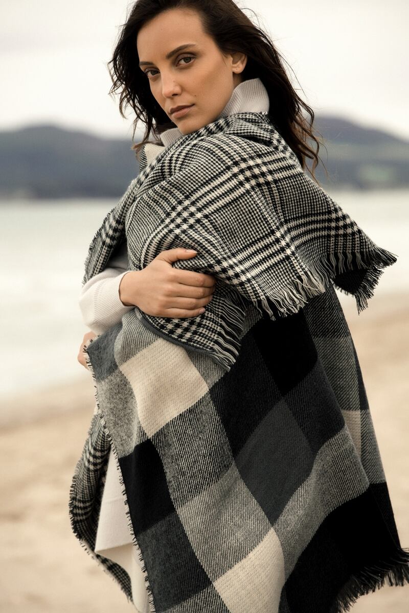 Black check wrap €39.99, grey cashmere cape €299.95, black trousers €45.99