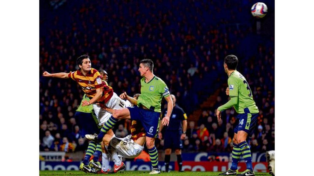 Bradford City's Irish defender Carl McHugh scores the third goal against Aston Villa during the League Cup clash at Valley Parade. photograph: paul ellis/afp