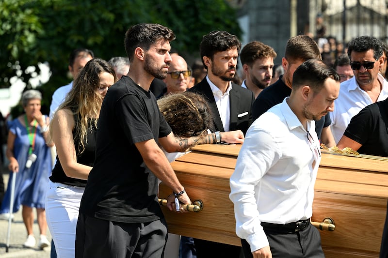 Rute Cardoso leans on the arm of Ruben Neves, football player for Alhilal Saudi Club and the Portugal national team, as the coffin of Diogo Jota is carried out. Photograph: Octavio Passos/Getty