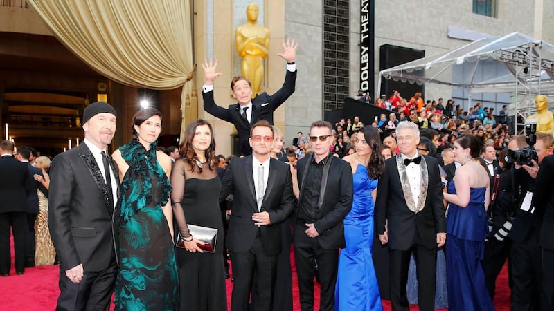Actor Benedict Cumberbatch jumps behind U2 at the 86th Academy Awards. Photograph: Mike Blake/Reuters