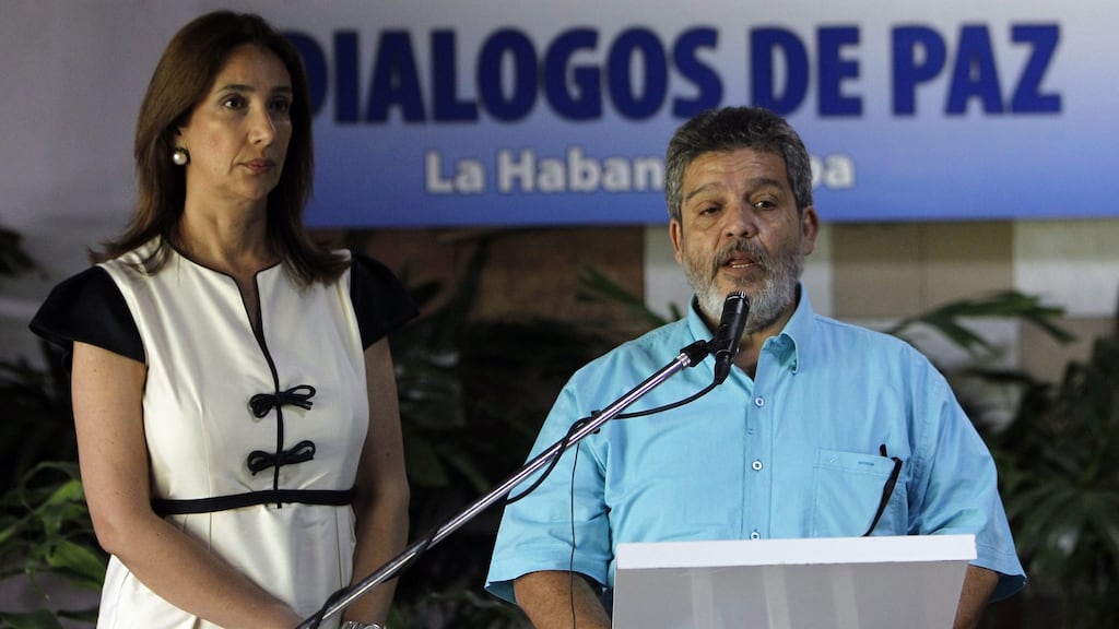 Colombian government press representative Marcela Duran and Farc representative Luis Alberto Alban announce that both sides have agreed a ‘definitive’ ceasefire. Photograph: Ernesto Mastrascusa/EPA