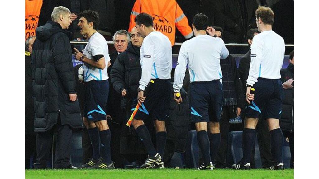 Arsenal's Manager Arsene Wenger (L) argues with referee Massimo Busacca during the second leg of their Champions League match against FC Barcelona at the Nou Camp. Photograph: Carl de Souza/AFP/Getty Images