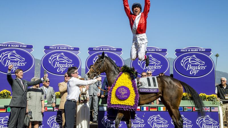 Lanfranco Dettori, leaps off of Queen’s Trust after winning the Breeders’ Cup Filly & Mare Turf in 2016 at Santa Anita Park in Arcadia, California. Photograph: Alex Evers/Breeders Cup via Getty