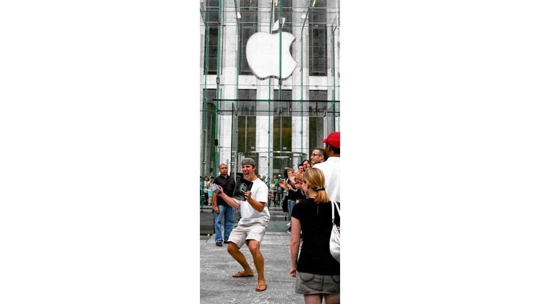 A customer outside New York's Apple Store in June 2007 after buying an iPhone Photograph: Don Emmert/Shaun Curry/AFP/Getty, Joe St Leger