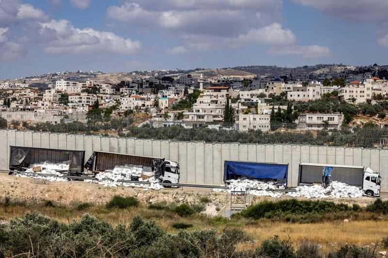 Trucks carrying humanitarian aid supplies along the separation barrier with the occupied West Bank after they had been vandalised by right-wing Israeli activists protesting against aid being sent to the Gaza Strip. Photograph: Oren Ziv/AFP/Getty