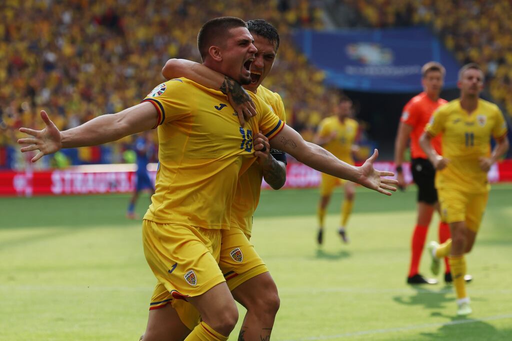 Razvan Marin of Romania celebrates with teammate Nicolae Stanciu. Photograph: Mohammed Badra/EPA