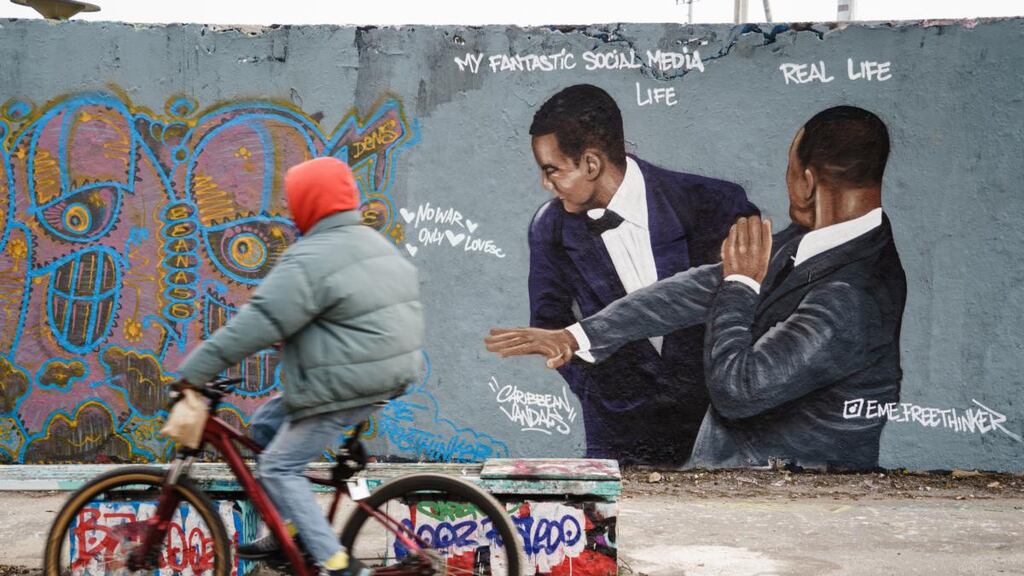 A graffiti mural of the notorious slap by Dominican artist Jesus Cruz Artiles, sprayed on a wall at Mauerpark park in Berlin. Photograph: Clemens Bilan/EPA