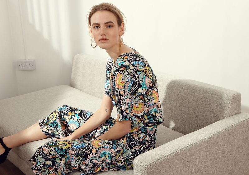 Printed floral dress €225 Max + Co., saddle bag €295 Michael Kors, earrings €89 Calvin Klein, West Elm Andes corner sofa €2699