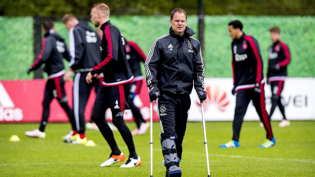 Ajax’s head coach Frank De Boer observes a training session in Amsterdam last week, in a foot brace after suffering a torn Achilles tendon. Photograph: EPA