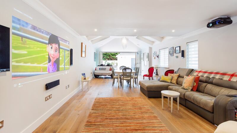 The house features an open-plan ground floor with an Epson home cinema