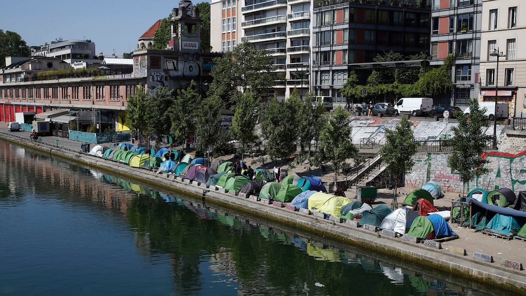 Tents where migrants live in a makeshift camp are packed alongside of the canal Saint-Martin in Paris on May 18th. Photograph: Francois Mori/AP