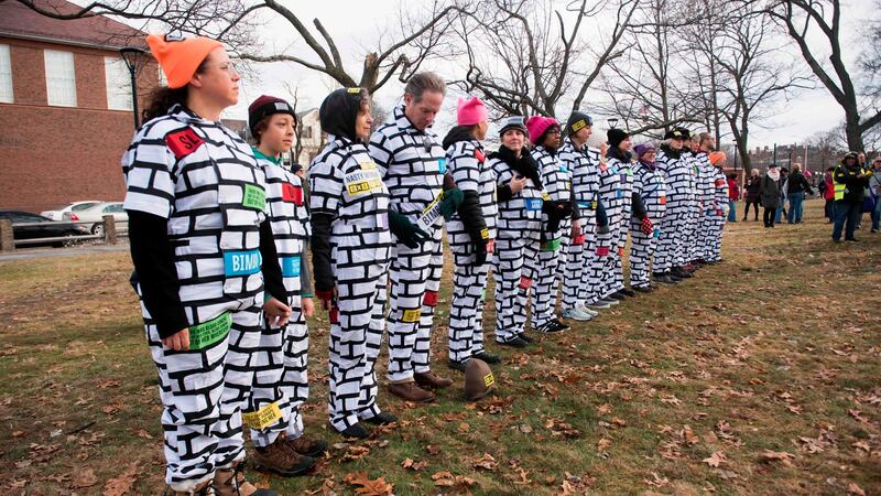 A group of rally goers form a “wall” with obscene language which has been used against women written on them, at Cambridge Commons in Boston, Massachusetts. Photograph: Ryan McBride/AFP/Getty Images