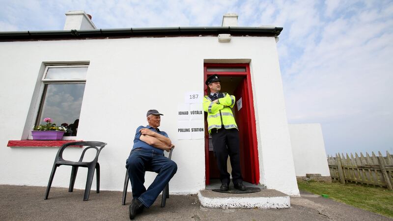 Garda  Pat McElroy chats with Jimmy Sweeney (left) whose home acted as a temporary polling station on Gola Island, off the Donegal coast. Photograph: Paul Faith/AFP/Getty Images