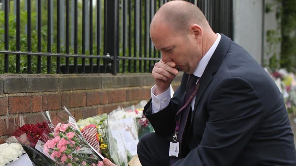 Steve Mort, head teacher of Corpus Christi Catholic College, reads the hundreds of tributes left in honour of slain teacher Ann Maguire on April 30th, 2014 in Leeds, England. A 15-year-old male student has been arrested in connection with the death of teacher. Photograph: Christopher Furlong/Getty Images