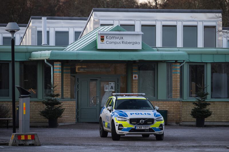 Police officers stand guard outside Campus Risbergska school in Örebro, Sweden, where the shooting took place. Photograph: Jonathan Nackstrand/AFP via Getty Images