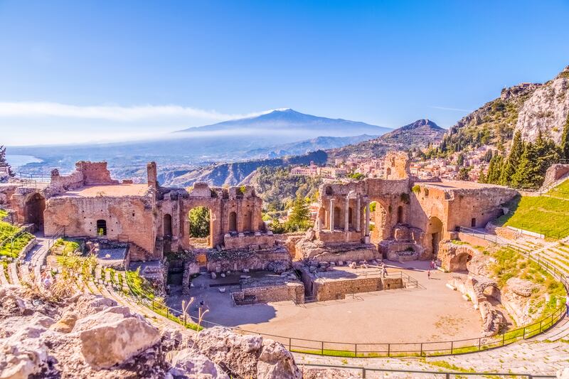 The Greek Theater of Taormina, flanked by smoking volcano Etna