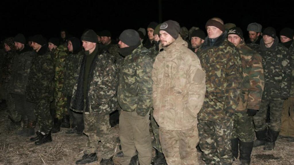 Ukrainian prisoners of war get ready to be exchanged for members of pro-Russian separatists near the village of Zholobok in Luhansk region, eastern Ukraine, on Saturday. Photograph:Igor Tkachenko/Reuters