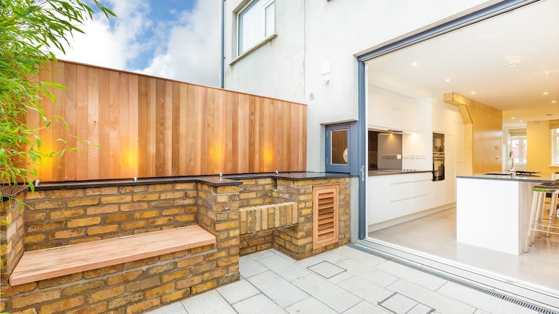 The rear patio has been finished with the house’s original yellow-coloured brick, which was salvaged during the construction.