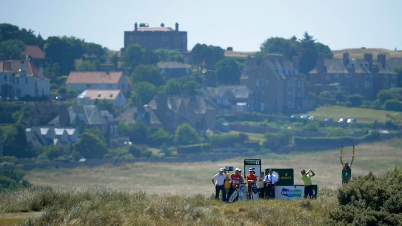 KJ Choi plays his tee shot through the haze on the fifth hole at Muirfield. Photograph: Russell Cheyne/Reuters