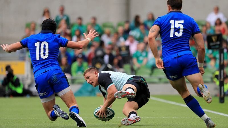 Andrew Conway of Ireland with Carlo Canna and Edoardo Padovani of Italy during the Guinness Summer Series match at the Aviva Stadium. Photograph: Donall Farmer/PA Wire.
