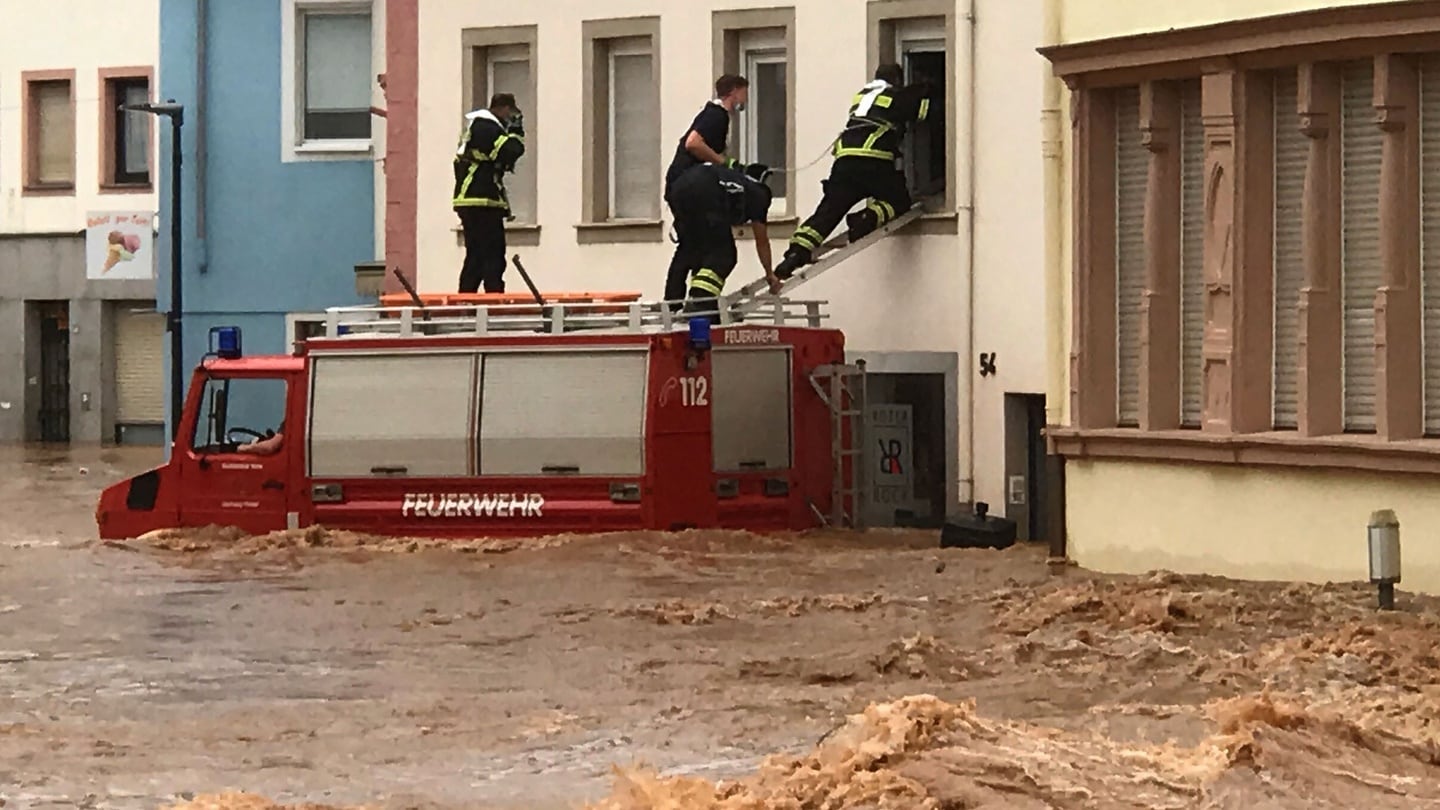 Firemen climb into a house in the flooded Ehrang neighbourhood in Trier, western Germany. Photograph: Fire Brigades City of Trier/AFP/Getty Images