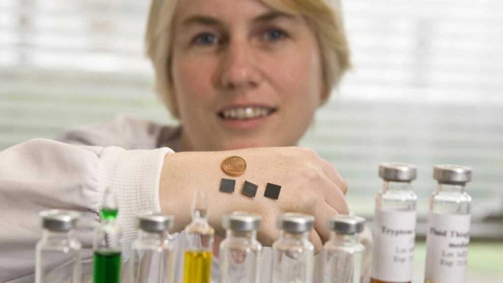 Dr Anne Moore, UCC School of Pharmacy, showing three of the small microneedle patches that could deliver better vaccinations. Photograph: Tomas Tyner/UCC.