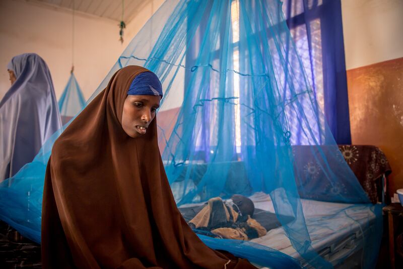 Fadumo Manur sits beside her two-year-old son in the malnutrition stabilisation ward of Bay Regional Hospital, Baidoa, Somalia. Photograph: Sally Hayden