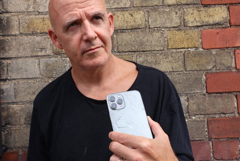 Conor Pope with his broken phone. Photograph: Dara Mac Dónaill