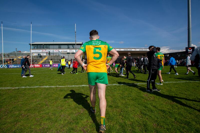 A dejected Caolan McColgan leaves the pitch after Donegal's  defeat to Down in the Ulster SFC quarter-final at Páirc Esler. Photograph: Morgan Treacy/Inpho
